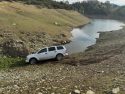San Andreas CHP Unit photo of an SUV stuck near New Hogan Lake in the Valley Springs area of Calaveras County reminding drivers to obey all signage regarding private property