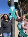 CNVC volunteers putting up teal ribbons in downtown Sonora -- photo by Pamela Orebaugh