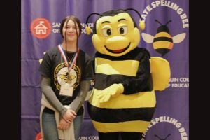 Selah England poses with the Spelling Bee mascot -- TCSOS photo