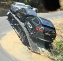 Truck hauling a trailer with three vehicles stuck at the hairpin turn in the Tuttletown area of Tuolumne County -- Photo taken by Gene Kahn
