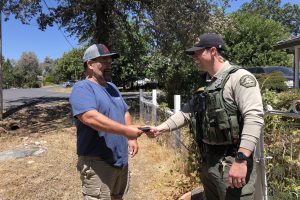 Sheriff's Deputy returning the wallet to its rightful owner—TCSO photo