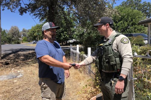 Sheriff's Deputy returning the wallet to its rightful owner—TCSO photo