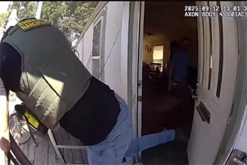 TCSO TNT member kicking the door in at the Jamestown residence—TCSO photo