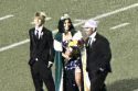 2025 Homecoming Queen for Sonora High, Addy Vann, escorted during the game by Matthew Burris on her left and her father, Mark Vann, on her right.