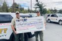ACSO Sergeant Kyle Wilson and Deputy Rick Tran holding check—ACSO photo