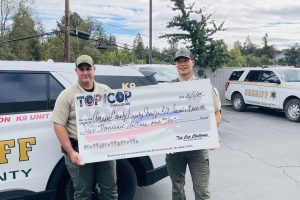 ACSO Sergeant Kyle Wilson and Deputy Rick Tran holding check—ACSO photo