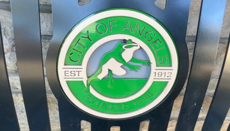 City of Angels Camp logo on bench in downtown