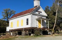Douglas Flat Schoolhouse being placed on new foundation