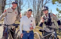 Iwata with the two unidentified TCSAR e-bike rescuers who found him—TCSO photo
