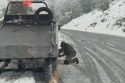 Driver pulled over on the fast lane shoulder and putting on chains—CHP photo