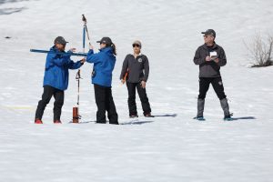 DWR official recording manual snowpack reading in Phillips Station in the Sierras—DWR photo