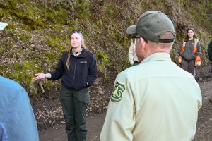 The Chief of the forest, Tom Schultz, with his back to the camera is given a tour of Lumsden Road—STF photo