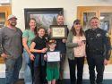 Sonora Police Chief Turu Vanderweil presenting Tammy Gillespie (both right) with a plaque with her family—Photo: Sonora City Council meeting