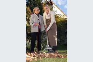 Volunteer helping rake leaves with the Area 12 Agency on Aging Chore Program—Agency photo