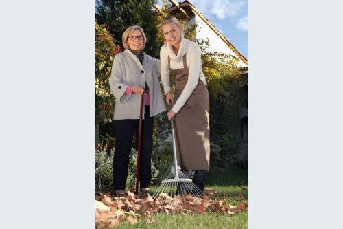 Volunteer helping rake leaves with the Area 12 Agency on Aging Chore Program—Agency photo