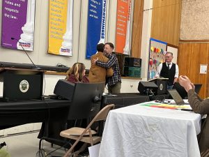 Anaiah Kirk and Tim McCaffrey embrace following debate 