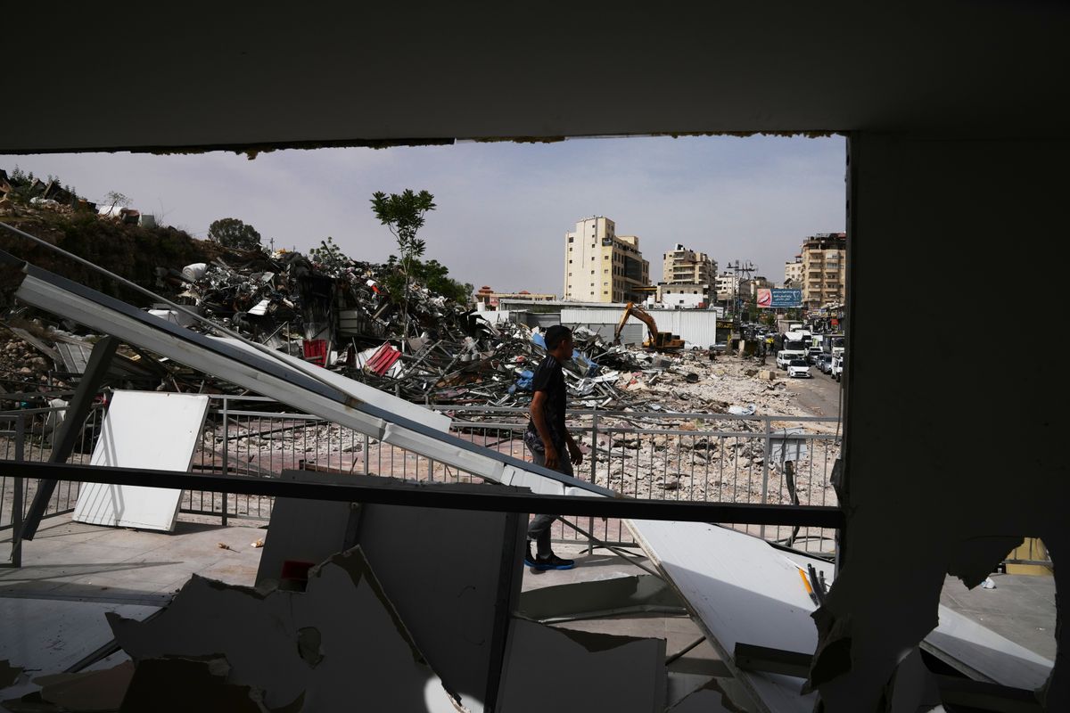 Israeli bulldozers raze about 50 Palestinian shops ahead of settlement-linked road project