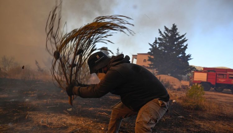 Photos show destruction from wildfires in Greece as blazes take hold in Europe and parts of the US