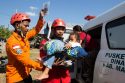 People await aid after powerful earthquake in Indonesia, in photos