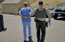 Andrew James Lee in handcuffs—TCSO photo