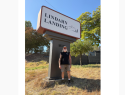 Roger Lindahn in front of Lindahn Landing sign - courtesy image