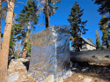The pumphouse wrapped in fire-resistant material to protect it from possible fire spread—YNP photo
